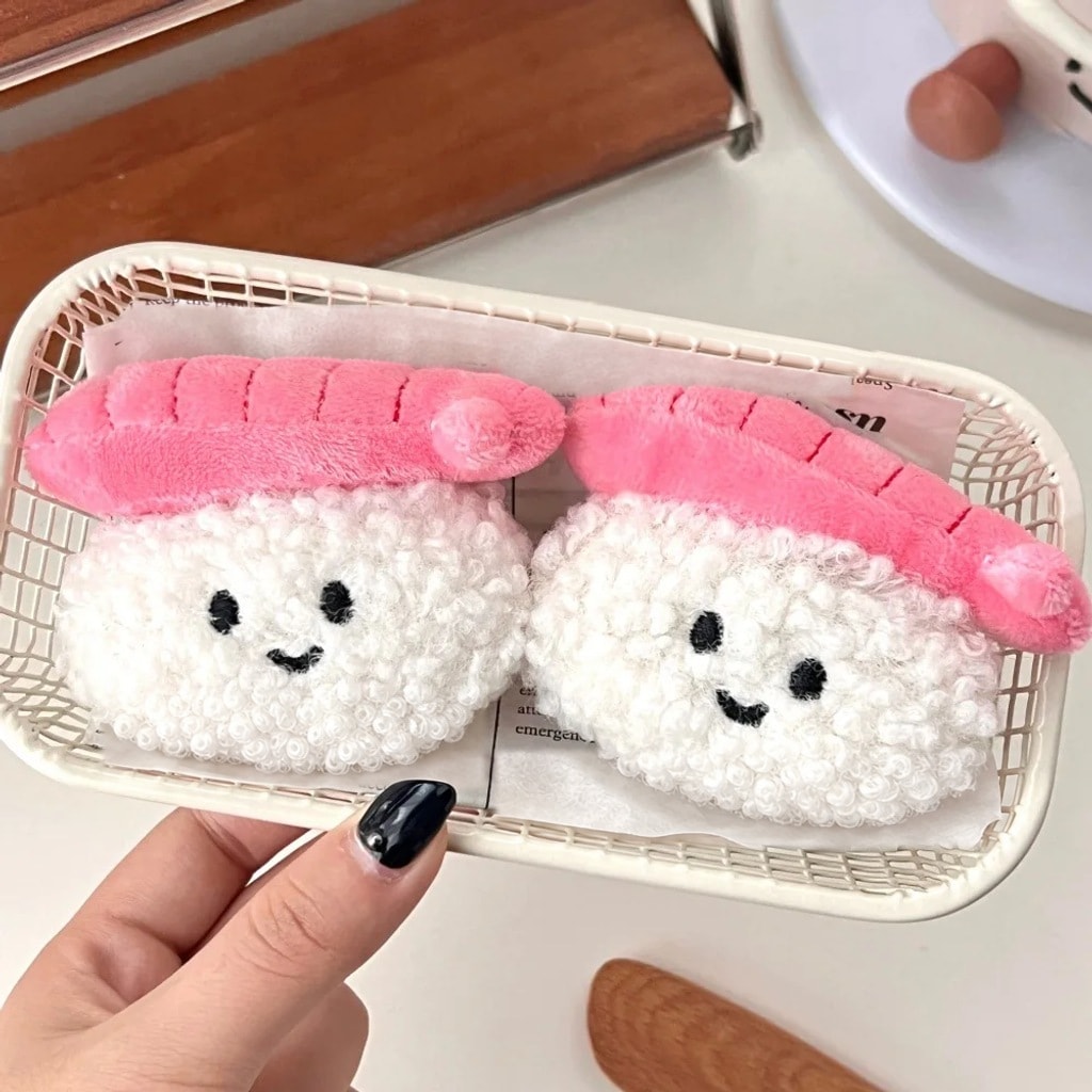 Dwa uśmiechnięte pluszowe breloczki sushi w koszyku